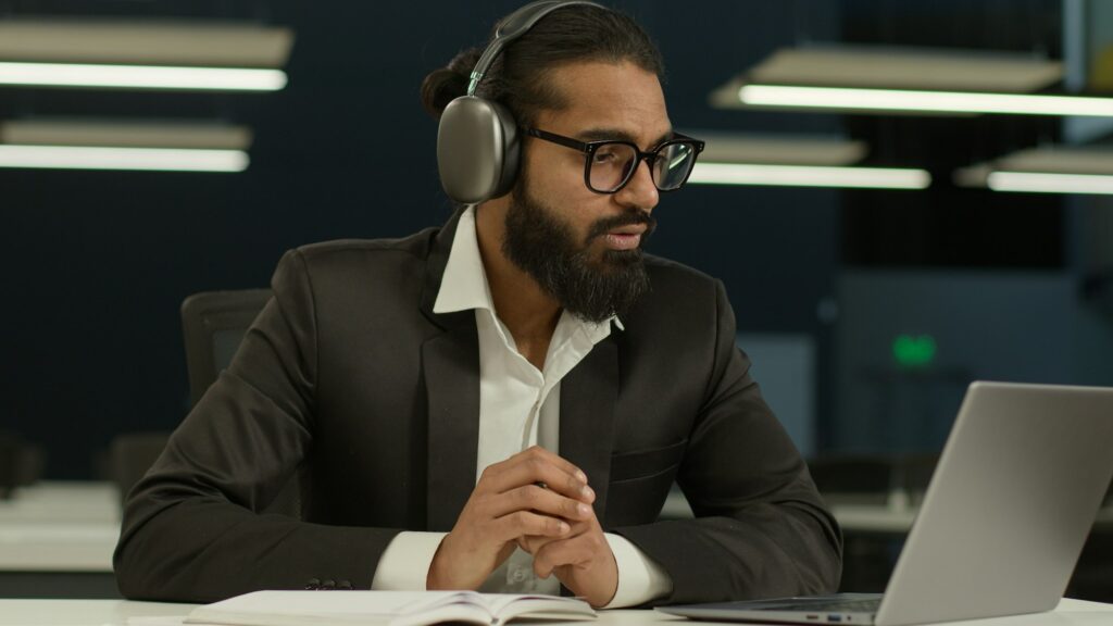 Arabian businessman distance class webinar lesson talk online students in office Indian business man